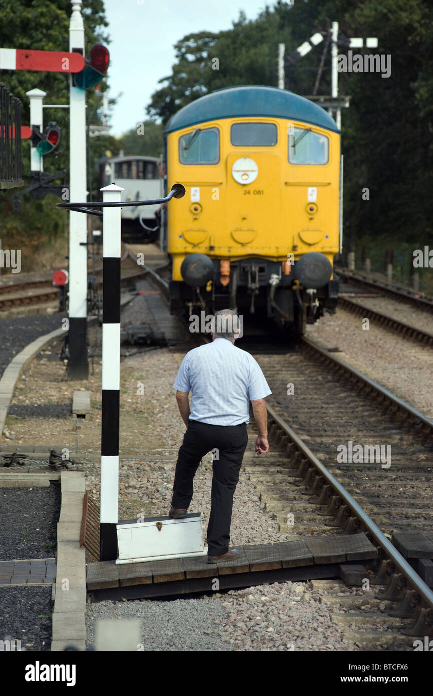 diesel train hands over line key at holt norfolk england Stock Photo