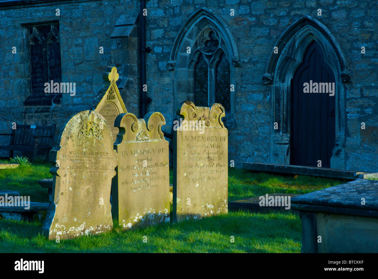 Gravestones in the churchyard of St Michael's Church, near the village of Linton, Wharfedale, Yorkshire Dales, England UK Stock Photo