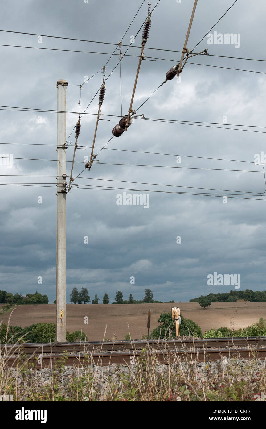 Electrified overhead lines over railway track on the midland main line, England. Stock Photo