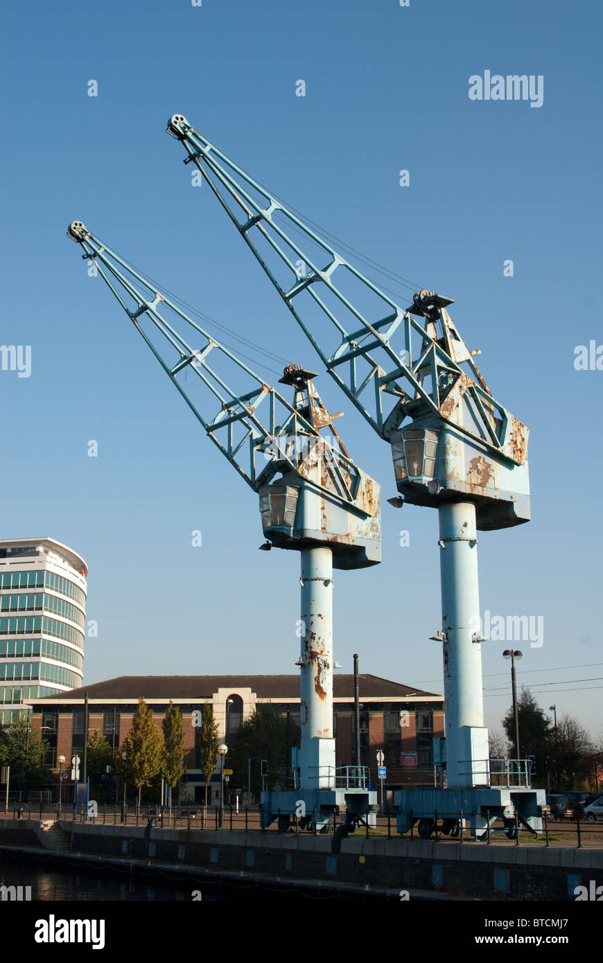 The two disused blue dock cranes at Salford Quays UK against a blue sky Stock Photo