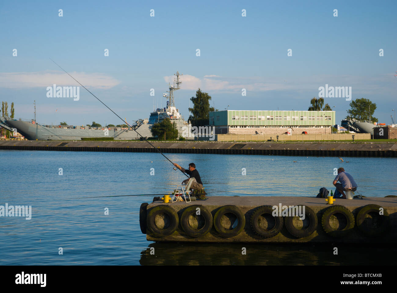 Men fishing at the port of Swinoujscie Pomerania Poland Europe Stock Photo