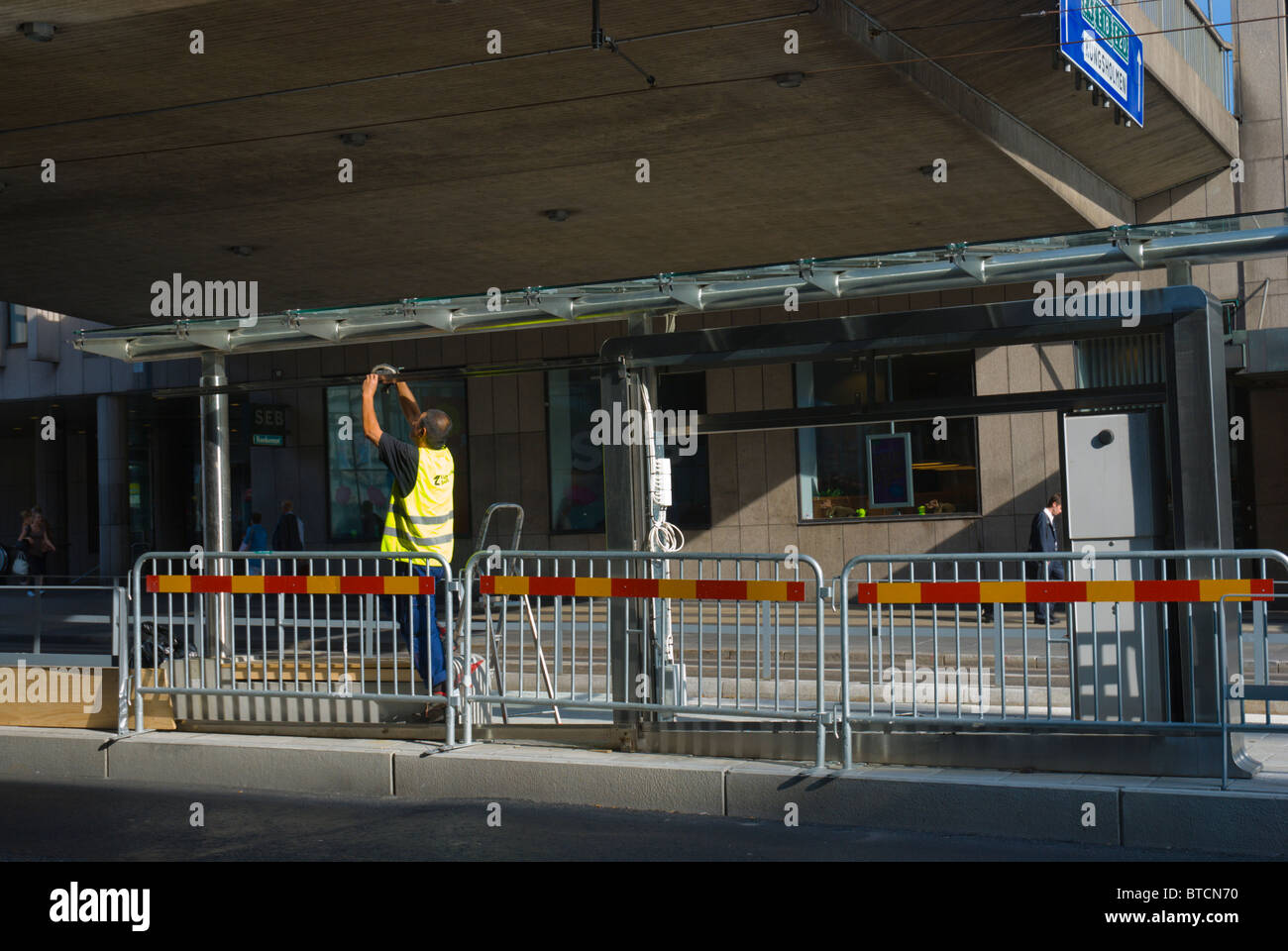 Worker instaling a shelter for tramway that begun operation in Aug 2010 central Stockholm Sweden Europe Stock Photo