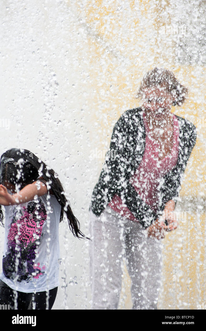 A woman and her daughter at the Appearing Rooms fountains on the ...