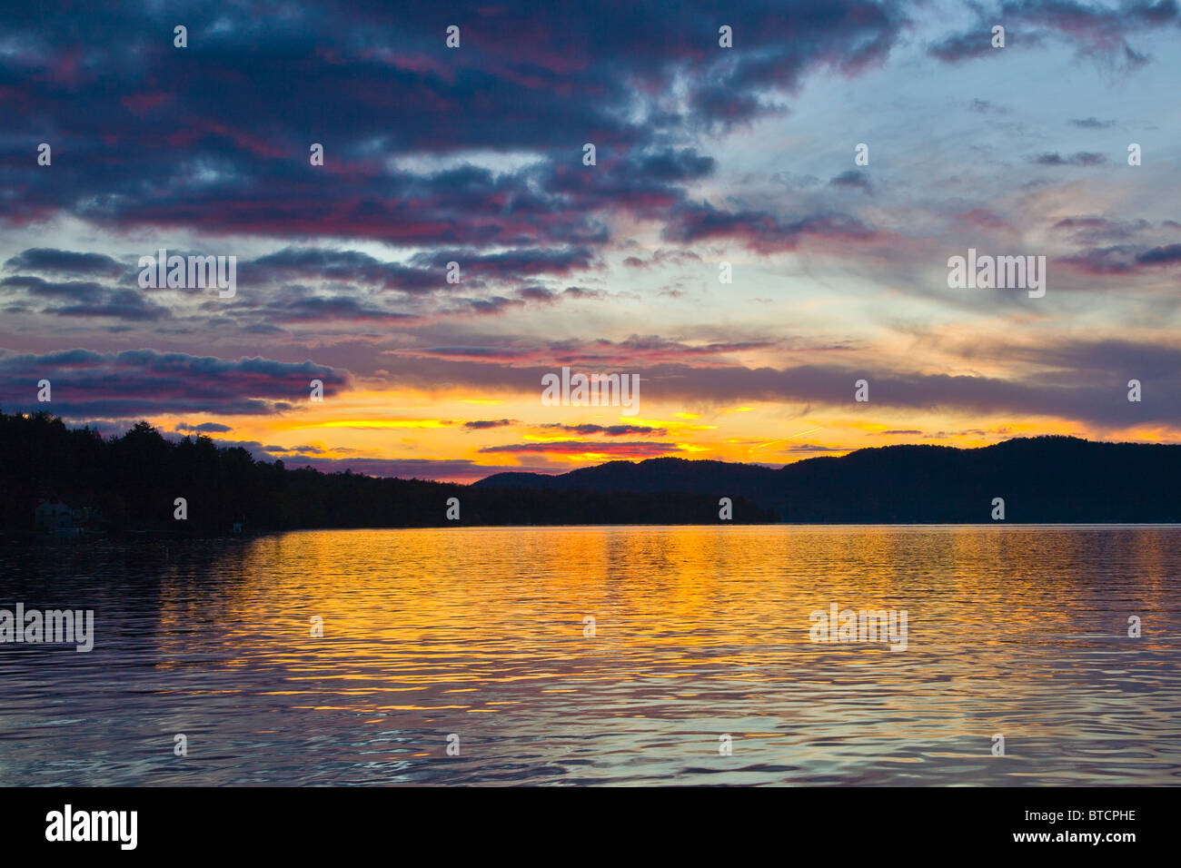 Sunset over Fourth Lake of the Fulton Chain of Lakes from Inlet in the Adirondack Mountains of New York State Stock Photo