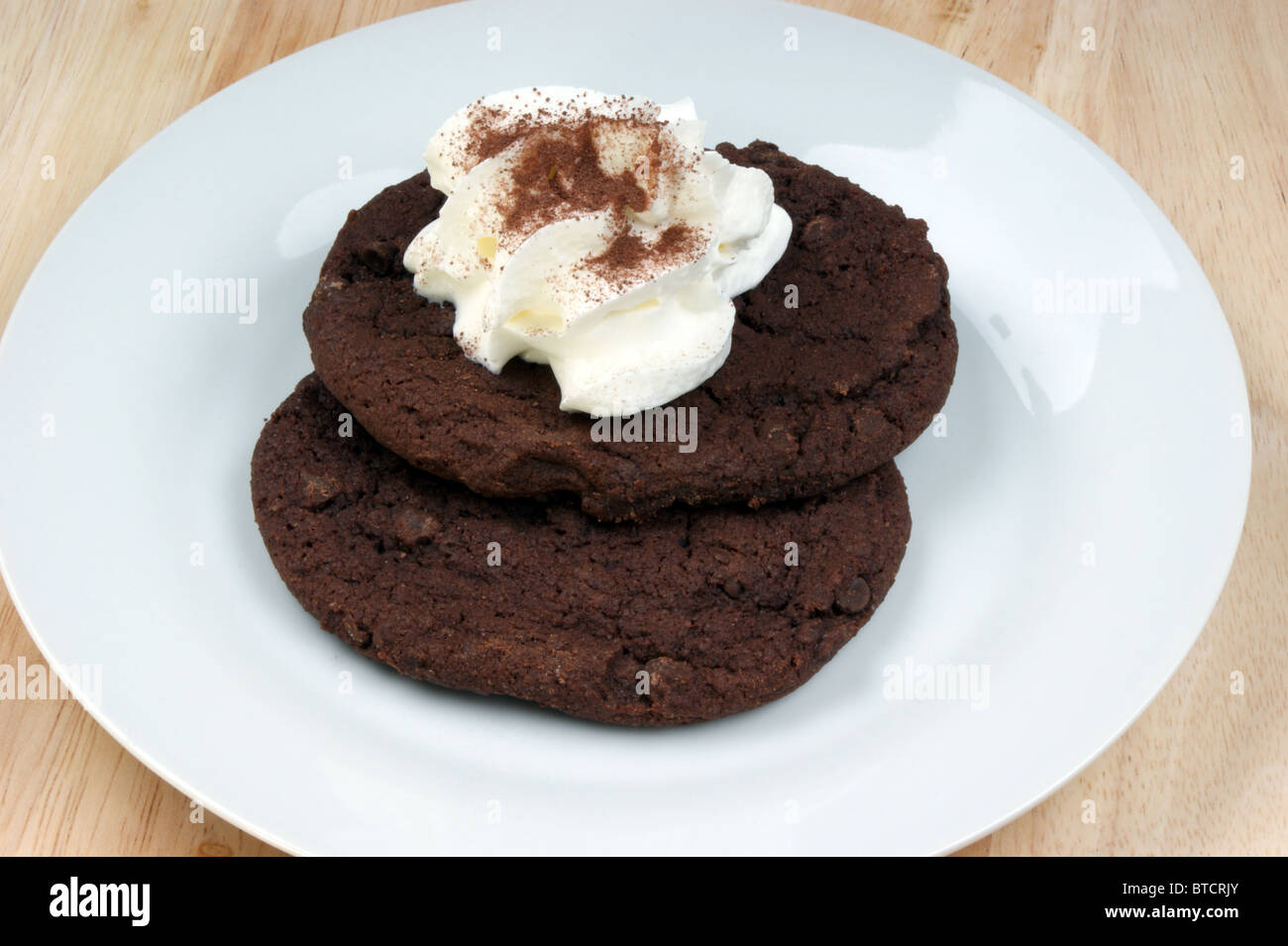 home made chocolate cake with cream on a plate Stock Photo - Alamy