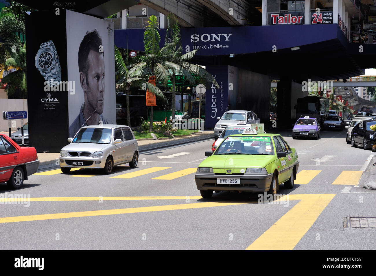 Traffic passing a large poster of Manchester United player Ryan Giggs in Kuala Lumpur, Malaysia Stock Photo