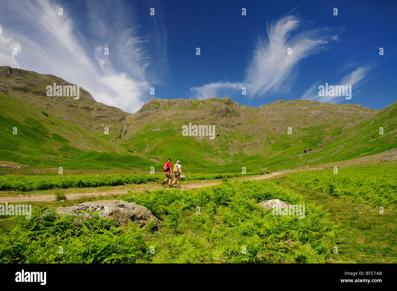 Walkers in the Mickleden Valley in summer, in the English Lake District