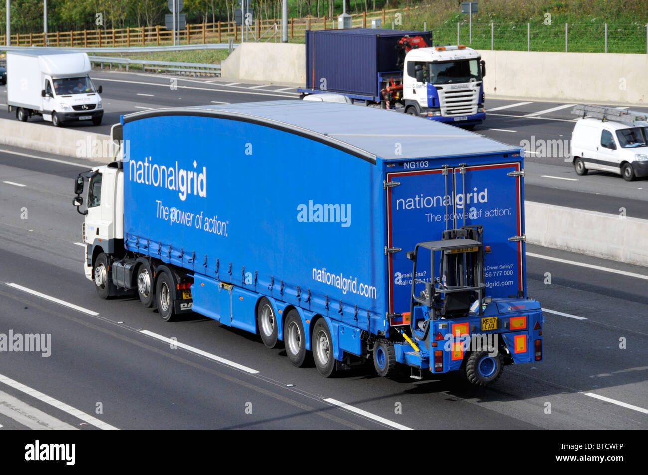 Gas National Grid lorry with fork lift truck carried on back end of trailer Stock Photo