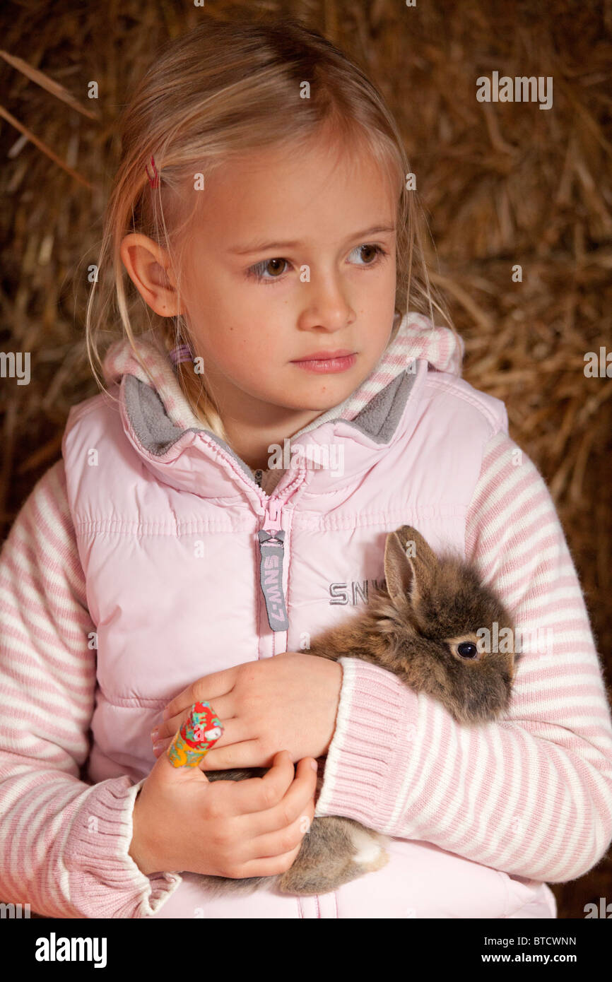 portrait of a little girl stroking a rabbit Stock Photo