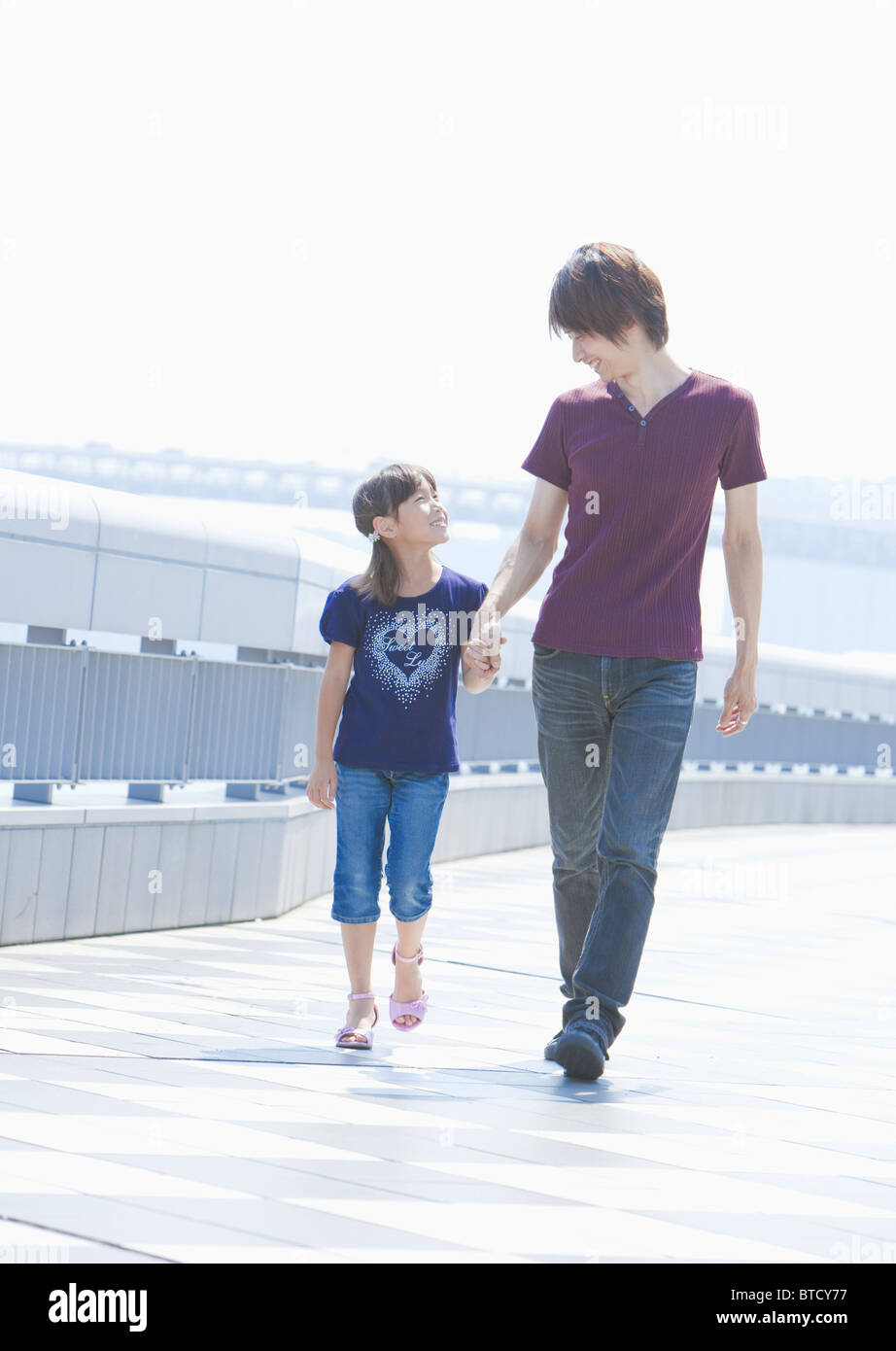 Father and daughter holding hands Stock Photo - Alamy