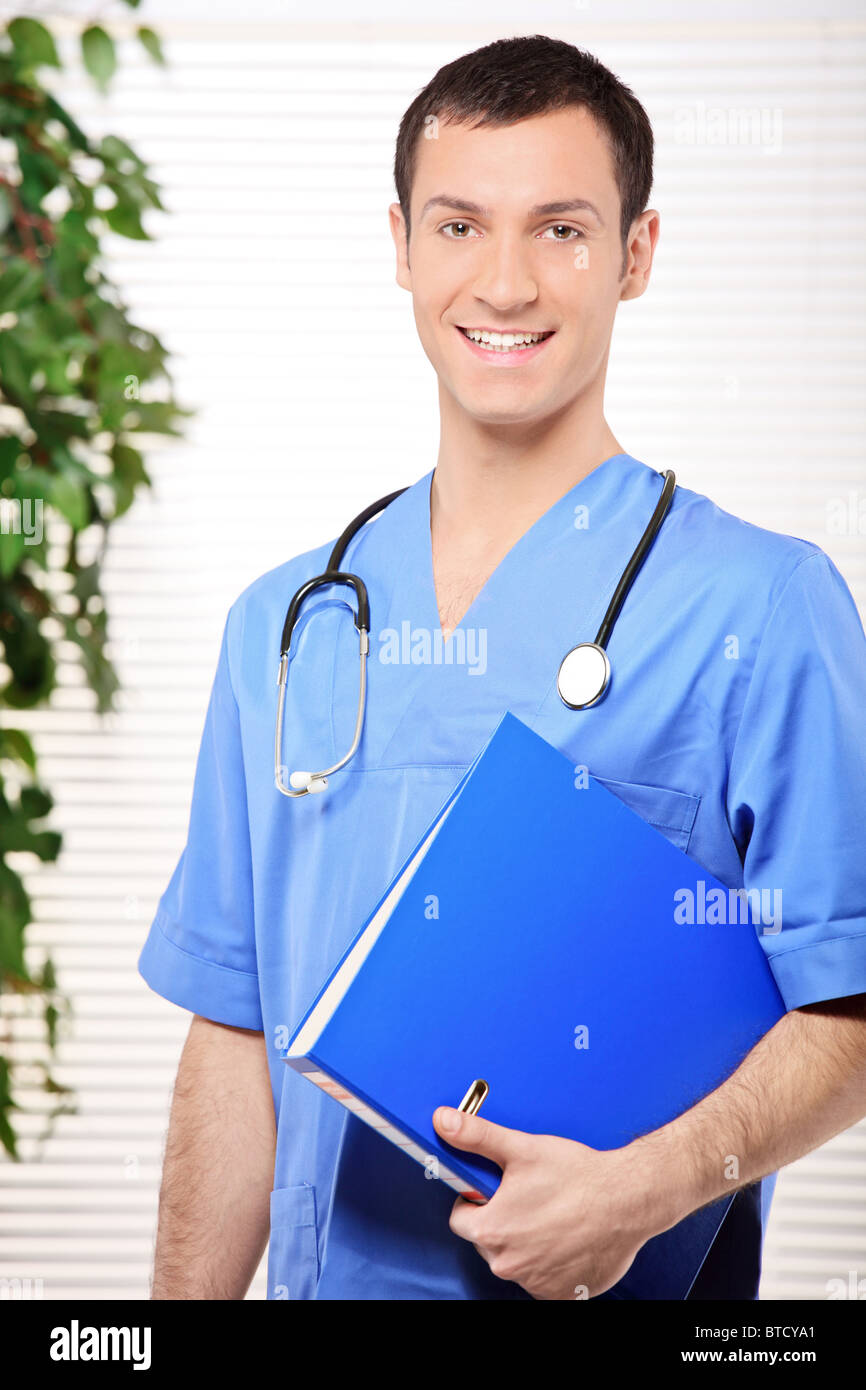 Smiling healthcare professional holding a folder of patient or medical information Stock Photo