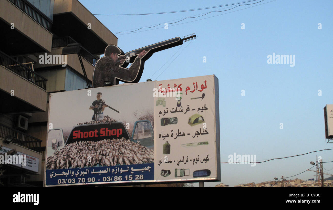 Lebanon, Beirut. Urban dream. Sign outside a hunting shop showing cut out of hunter and birds he has shot Stock Photo