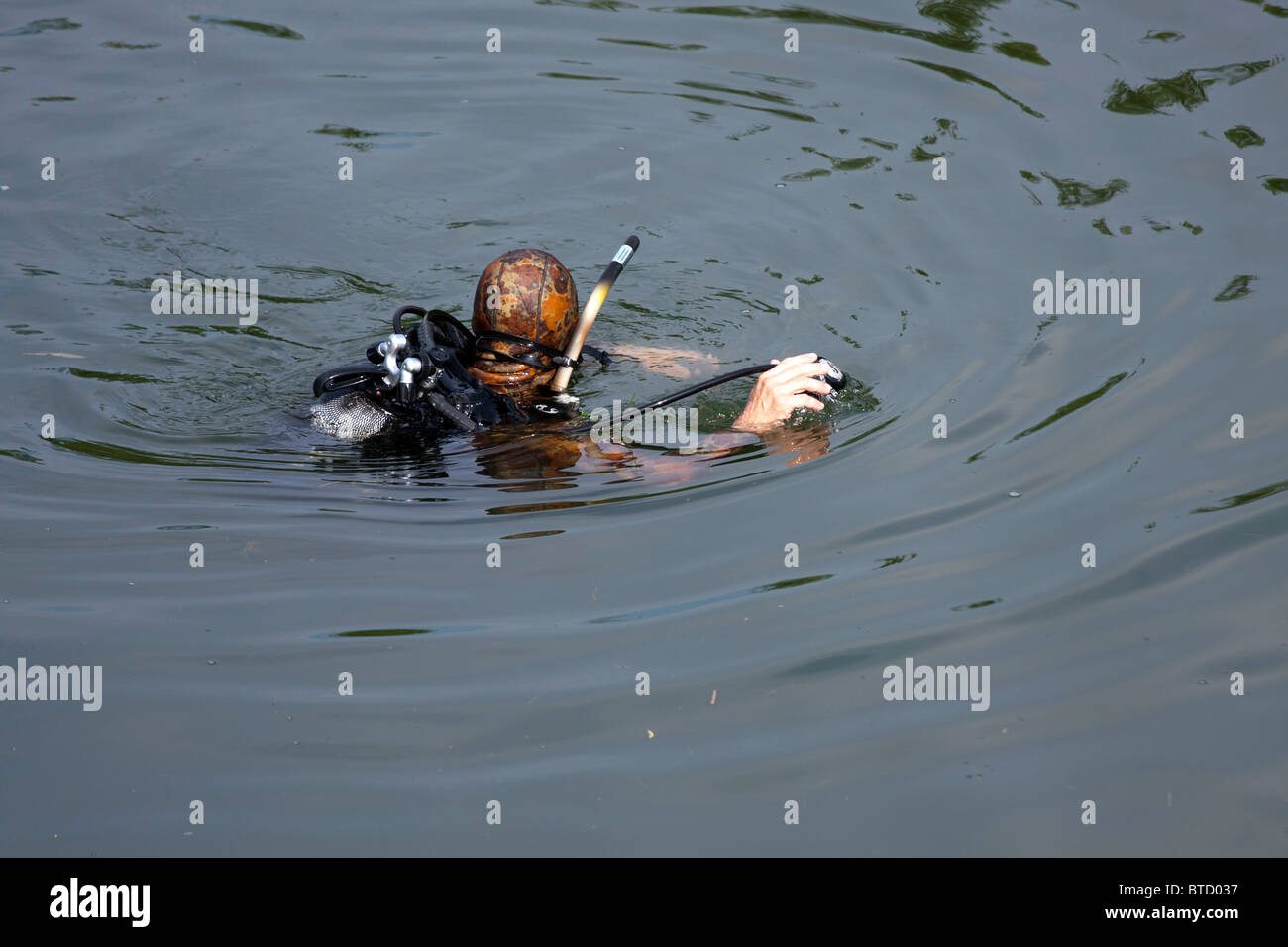 Underwater diver in military clothes in the water. Stock Photo