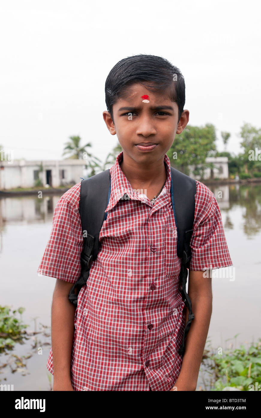 A boy  waiting to go to school, Alappuzha, Kerala, India. Stock Photo