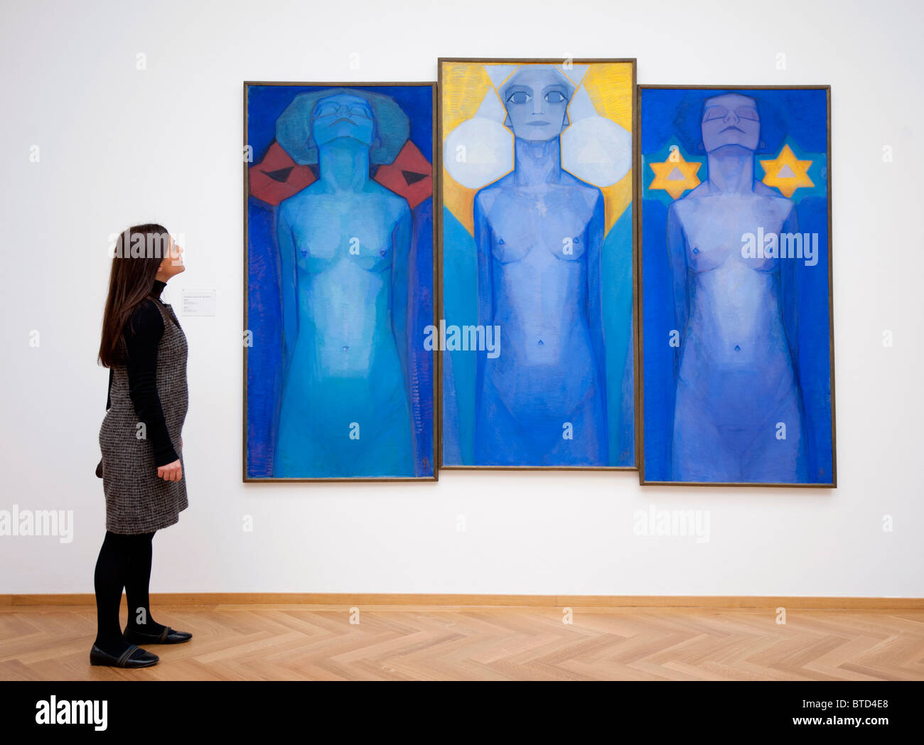 Woman looking at painting Evolution by Piet Mondriaan at Gemeentemuseum in The Hague, Den Haag, Netherlands Stock Photo