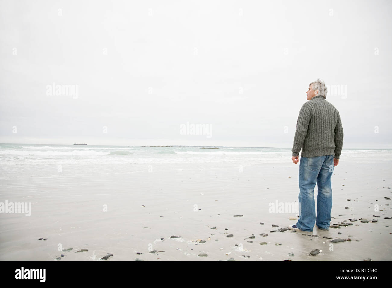 Mature man standing on beach hi-res stock photography and images - Alamy