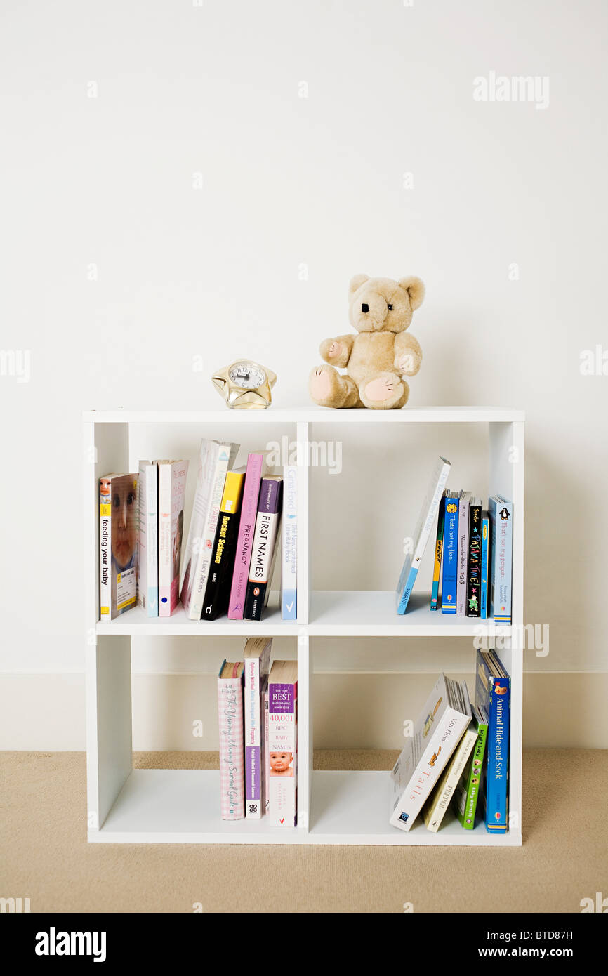 Bookshelf with books and toys Stock Photo Alamy