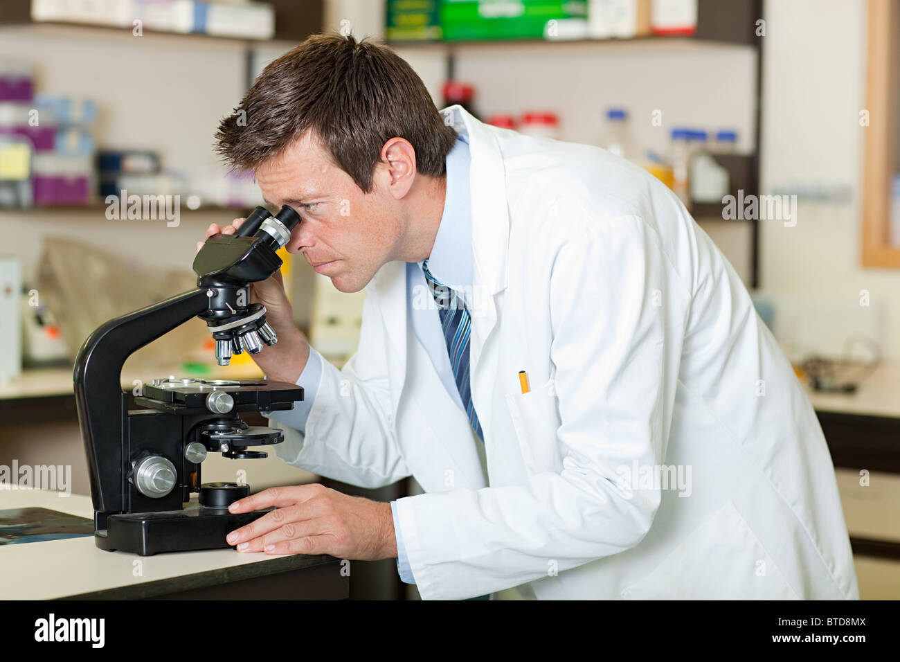 Doctor using microscope Stock Photo Alamy