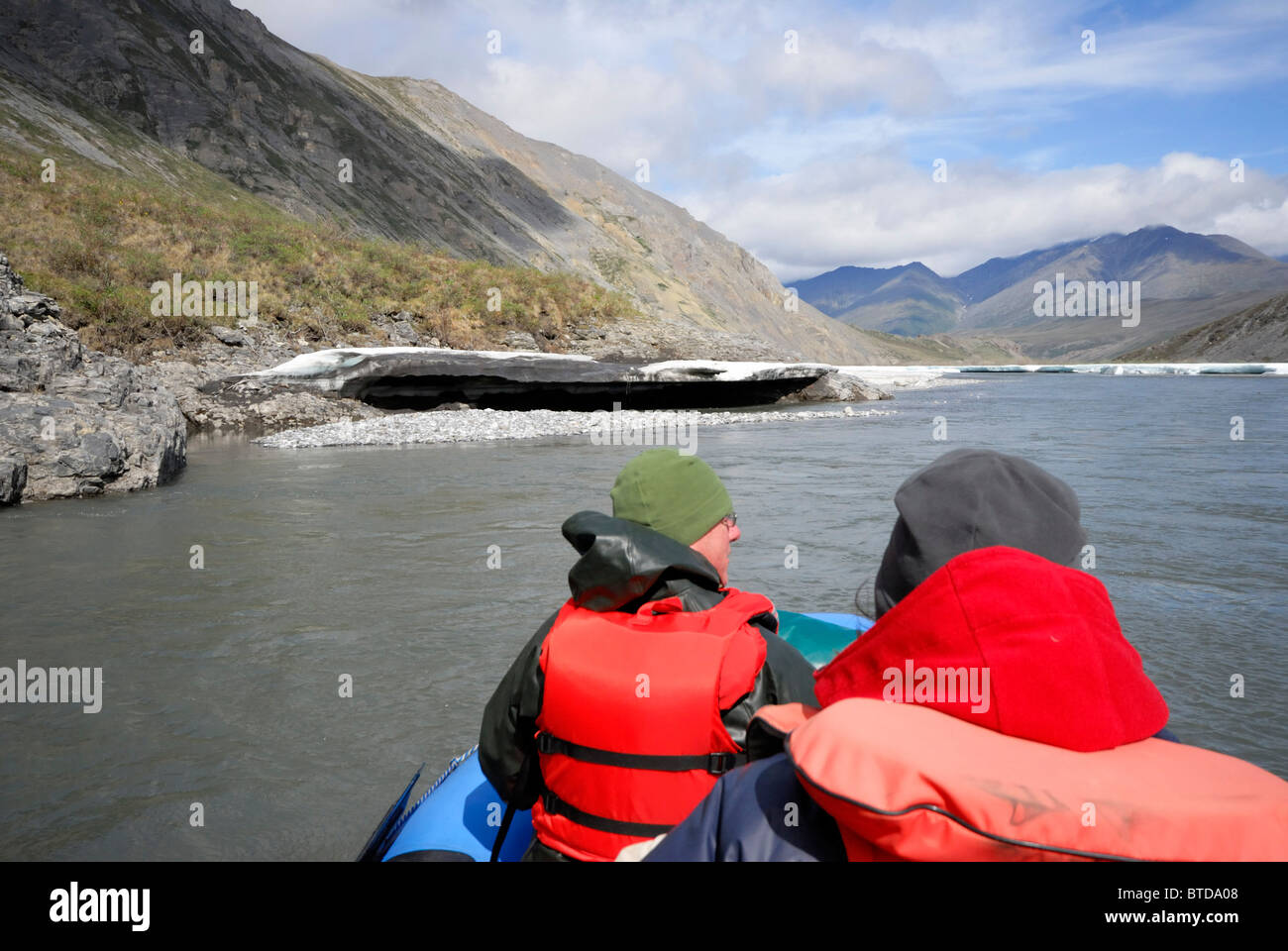 Two rafters view sheets of aufeis ice along the Kongakut River while