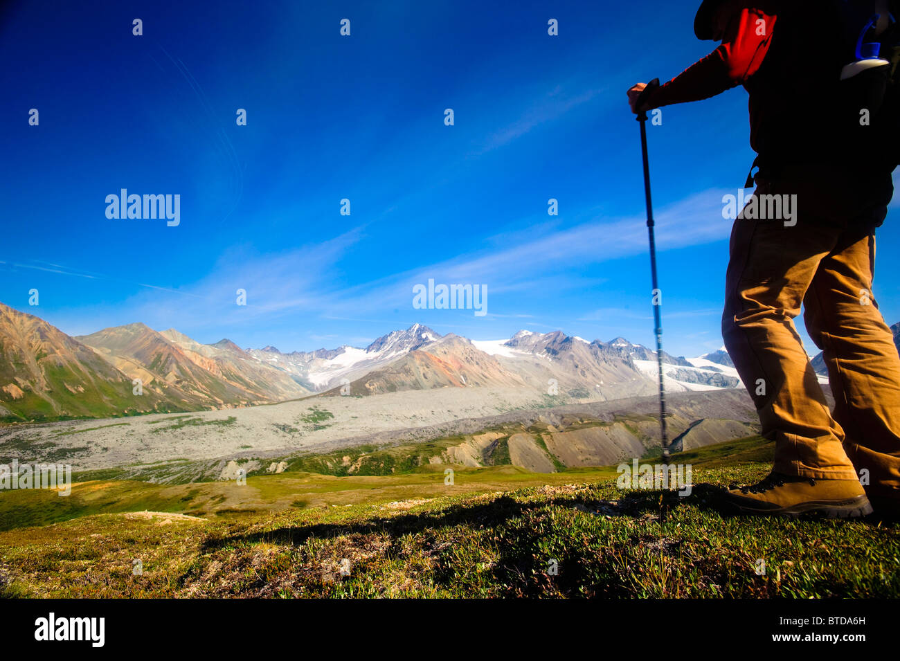 Male backpacker views Gulkana Glacier while hiking in the Alaska Range