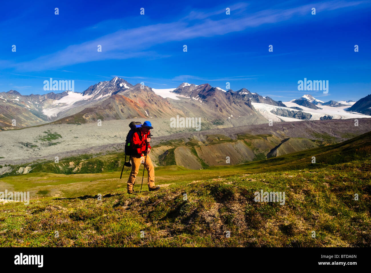 Male backpacker views Gulkana Glacier while hiking in the Alaska Range