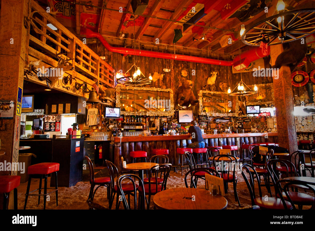 Tourist sits at the bar of the Red Dog Saloon in Juneau, Southeast