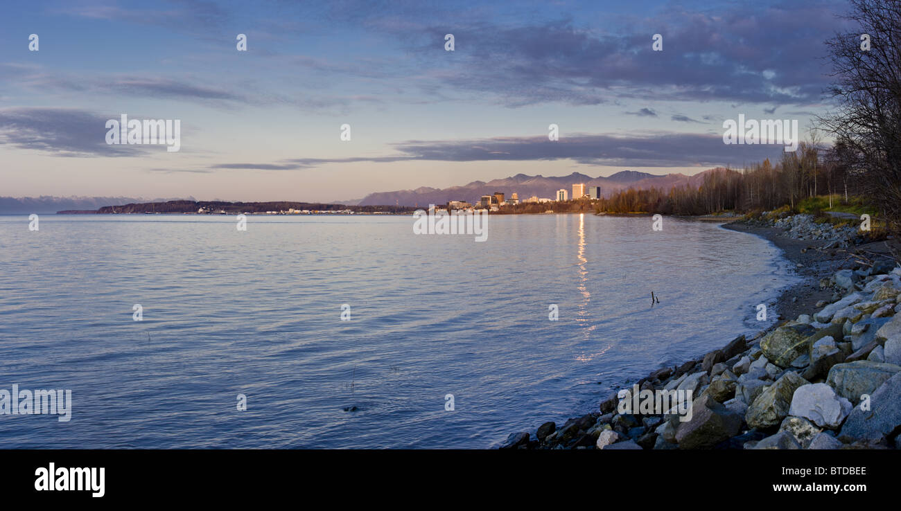 View of the Anchorage skyline reflecting in the waters of Cook Inlet at sunset, Southcentral Alaska, Fall Stock Photo