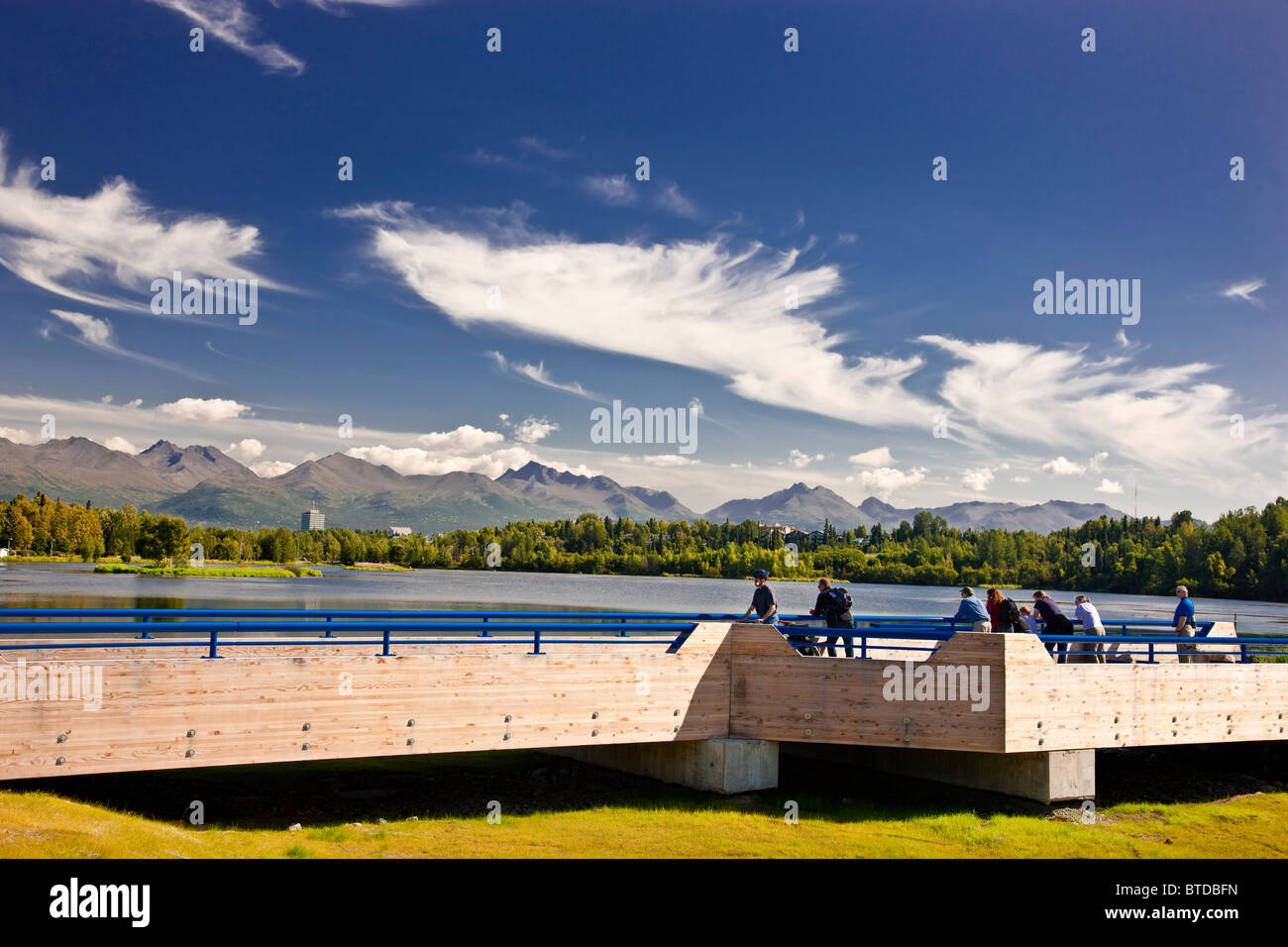 View of Westchester Lagoon with the Tony Knowles Coastal Trail fish viewing platform in the foreground during  Anchorage, Alaska Stock Photo