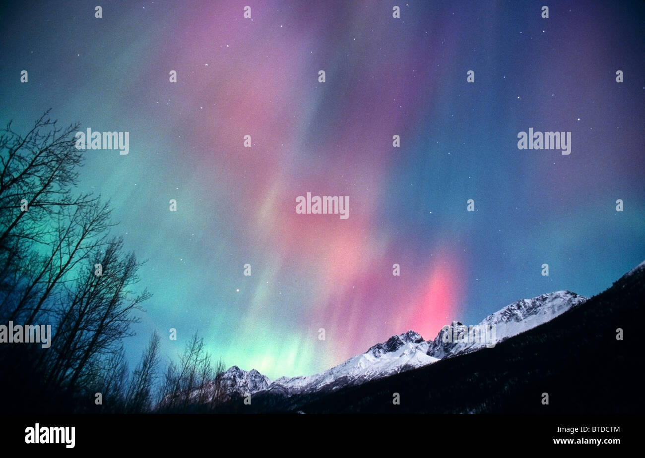 Multi colored Northern Lights (Aurora borealis) fill the night sky off the Old Glen Highway near Palmer, Alaska, Winter Stock Photo