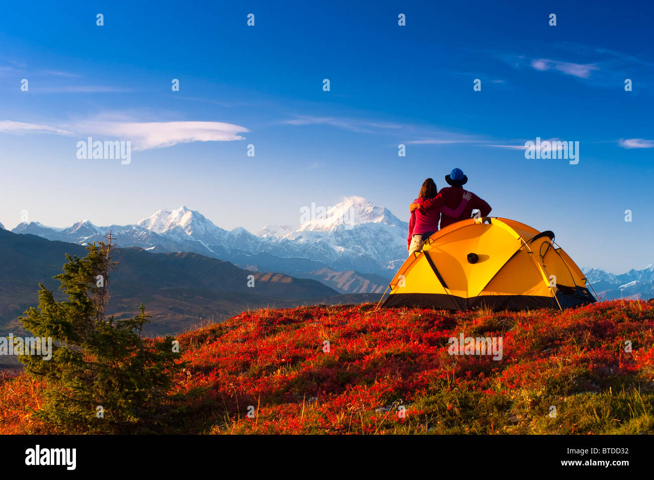 A couple view Mt.McKinley from their campsite in Peters Hills, Denali State Park, Southcentral Alaska Stock Photo