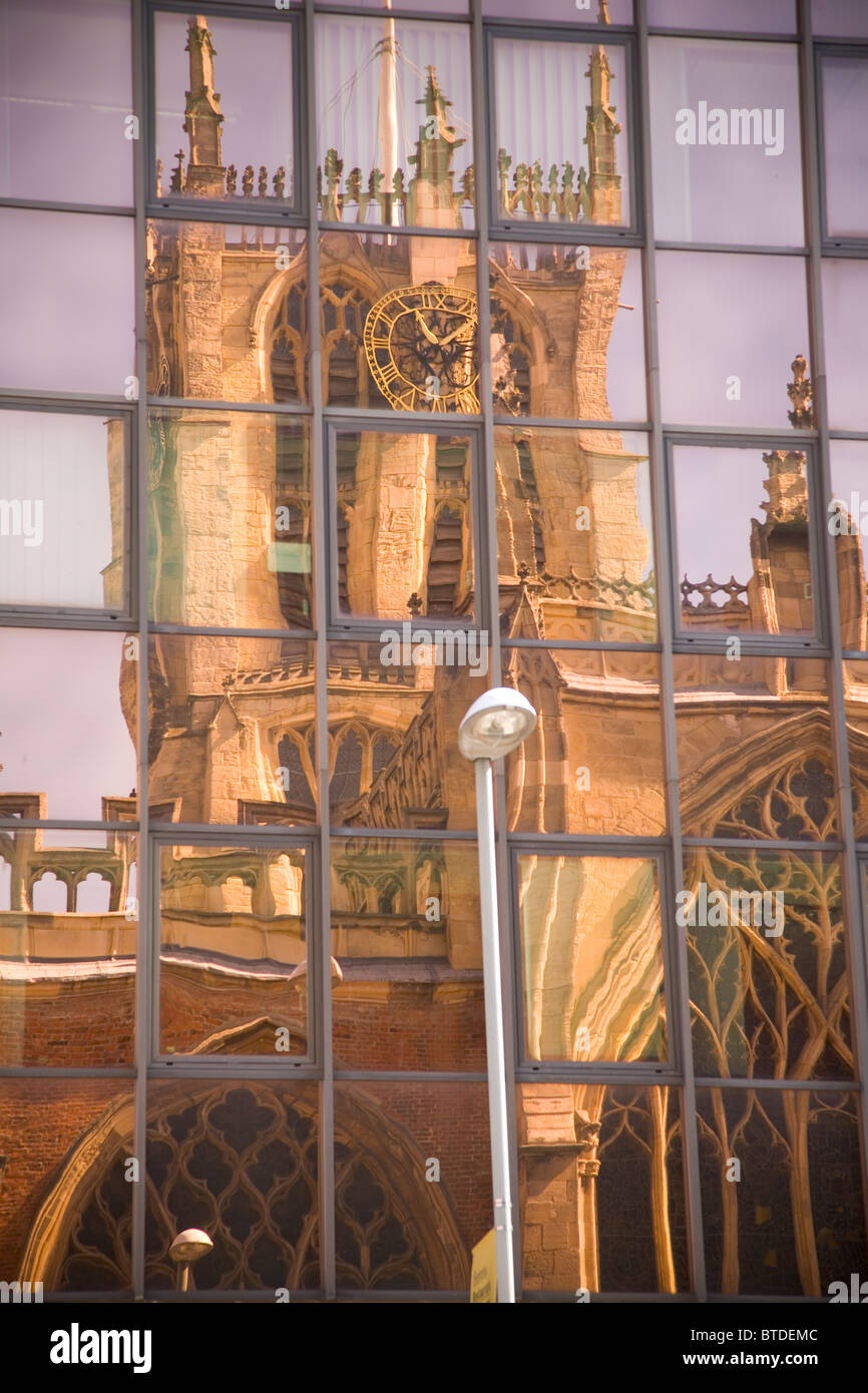 Reflection of Trinity church in building windows, Kingston upon Hull Stock Photo