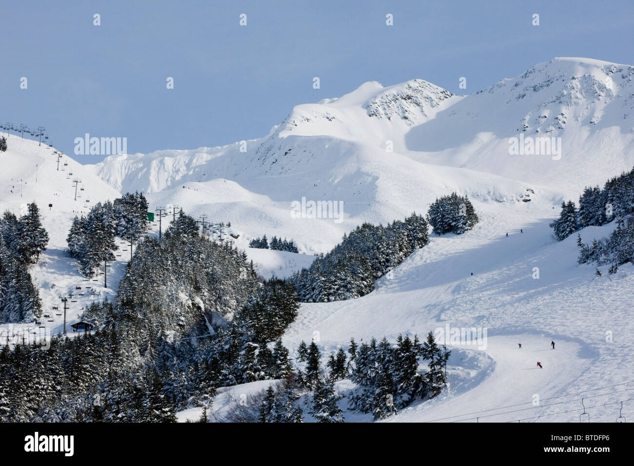 View of downhill skiiers on the slope of Mt. Alyeska at the Alyeska Resort in Girdwood, Southcentral Alaska, Winter Stock Photo