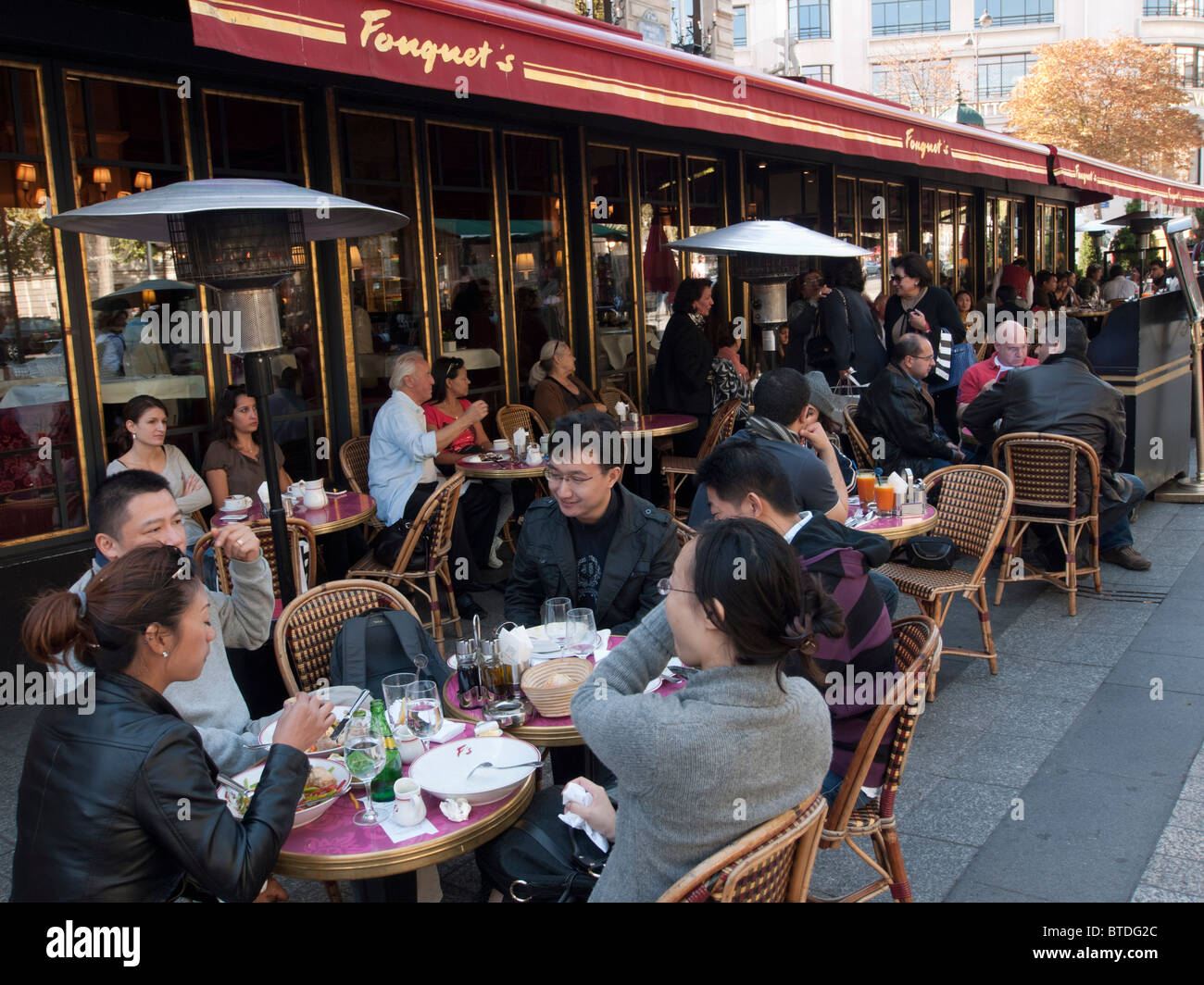 Tourists eating at Fouquet's restaurant on the Champs, Elysees in Paris