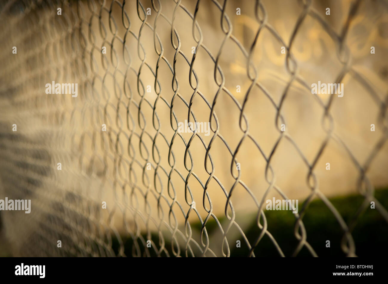 Wire fence (cyclone fencing) in repeating patterns Stock Photo