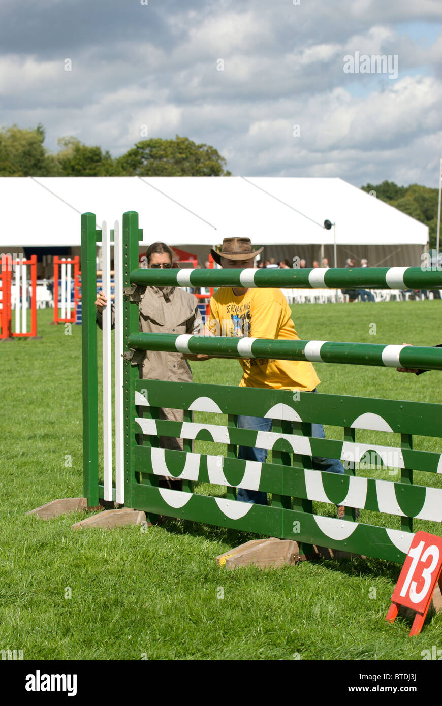 Setting up the jumps for the main ring Area Trial show jumping at Edenbridge and Oxted Agricultural show at Lingfield in Surrey Stock Photo