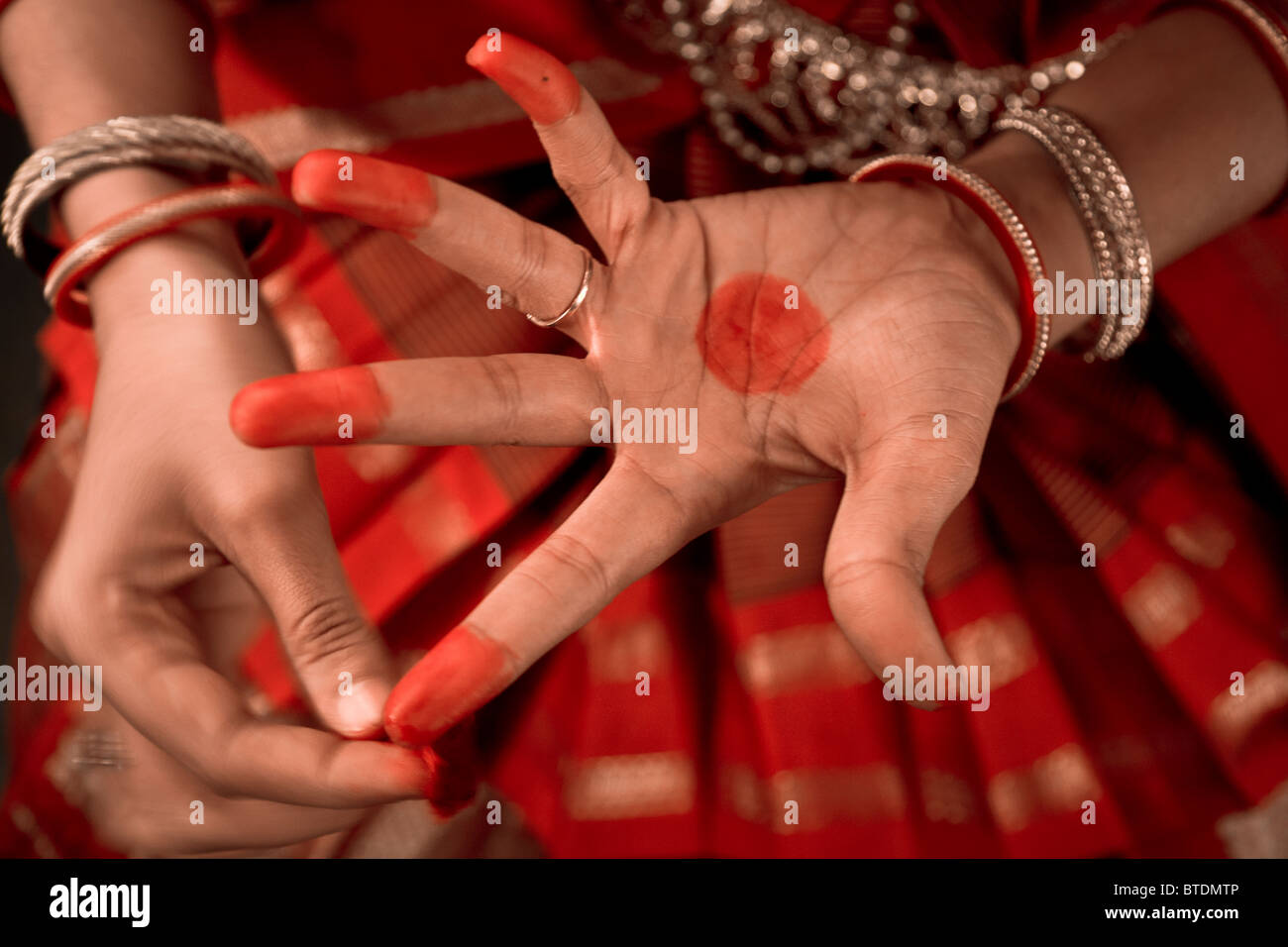 Ganga Thampi, applies make up to her hands shortly before taking the staring role of Sita in the Indian epic Ramayana. She is bo Stock Photo