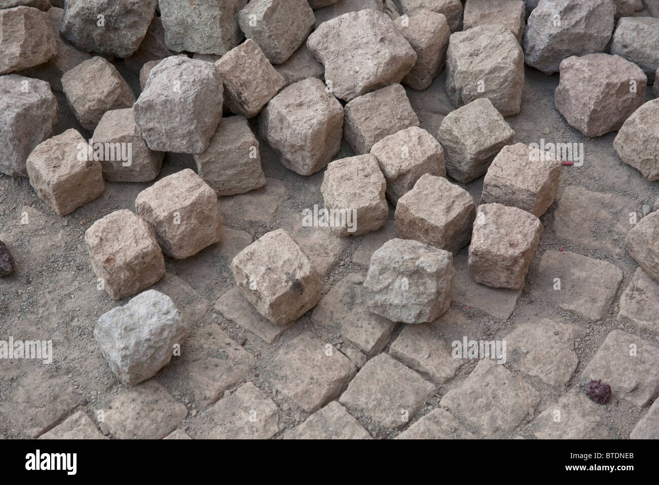 Hand-hewn cobble stones and a section of laid pavement Stock Photo