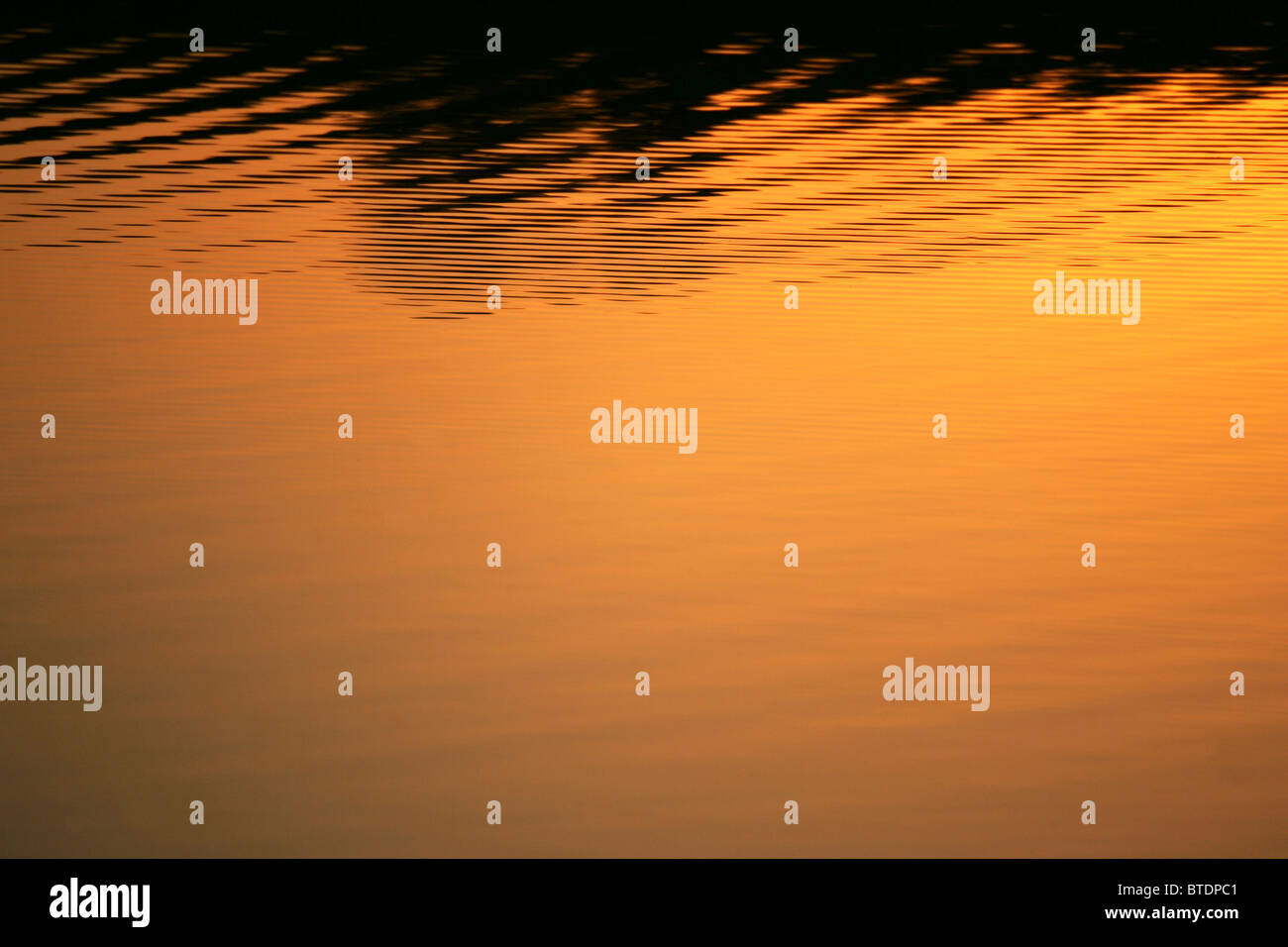 An abstract image of calm water at sunset Stock Photo