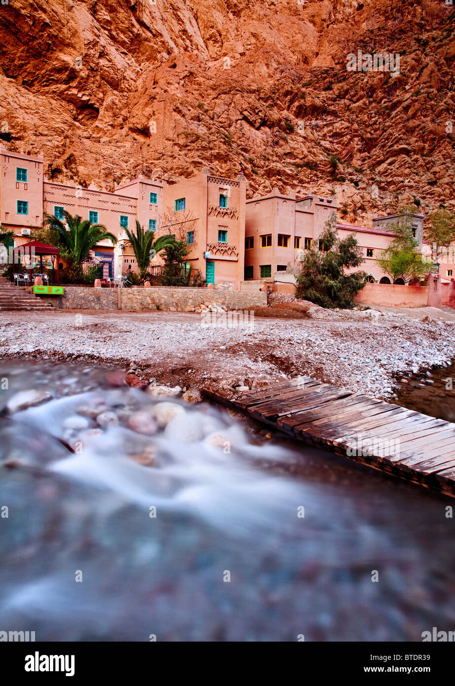 A river by passes some Moroccan Hotels in the Todra Gorge in the Mid Atlas region of Morocco Stock Photo