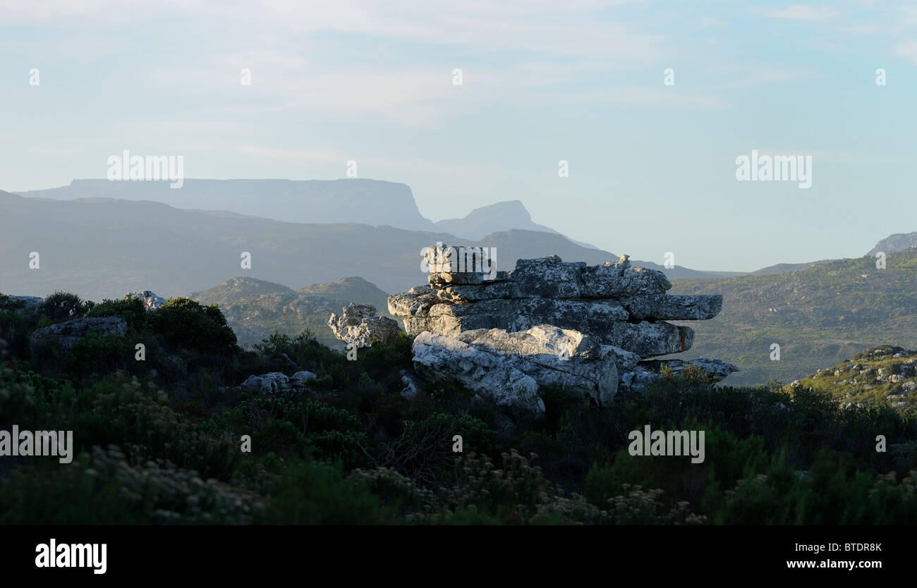 A scenic view of a rock outcrop with iconic Table Mountain in the background Stock Photo