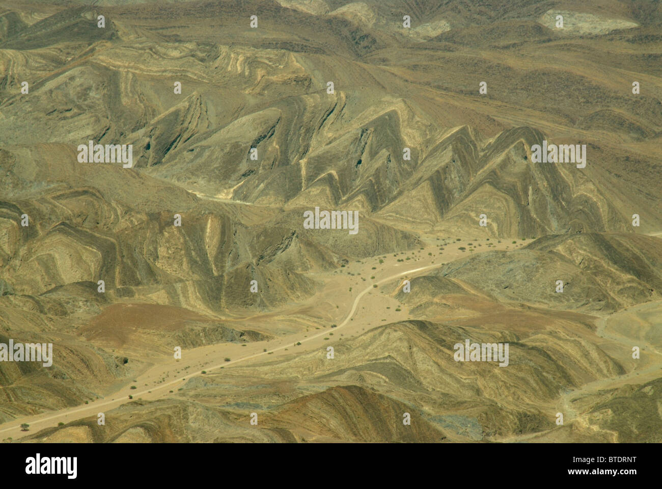 Aerial scenic view of a road passing through erosion and geological features, north of Swakopmund Stock Photo