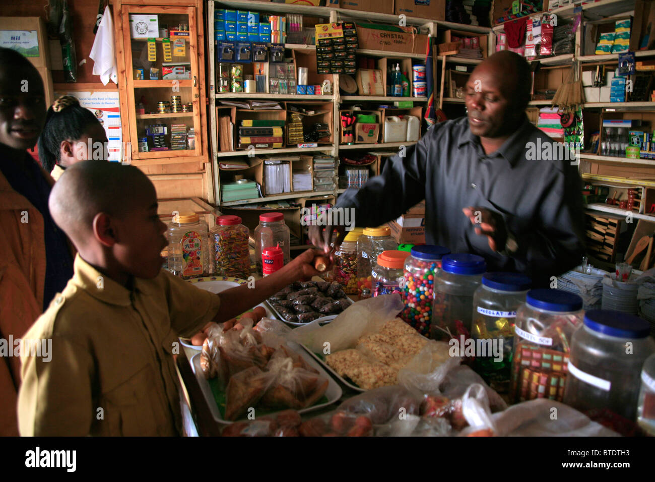 A young boy buying sweets at a small general store in the town Stock Photo
