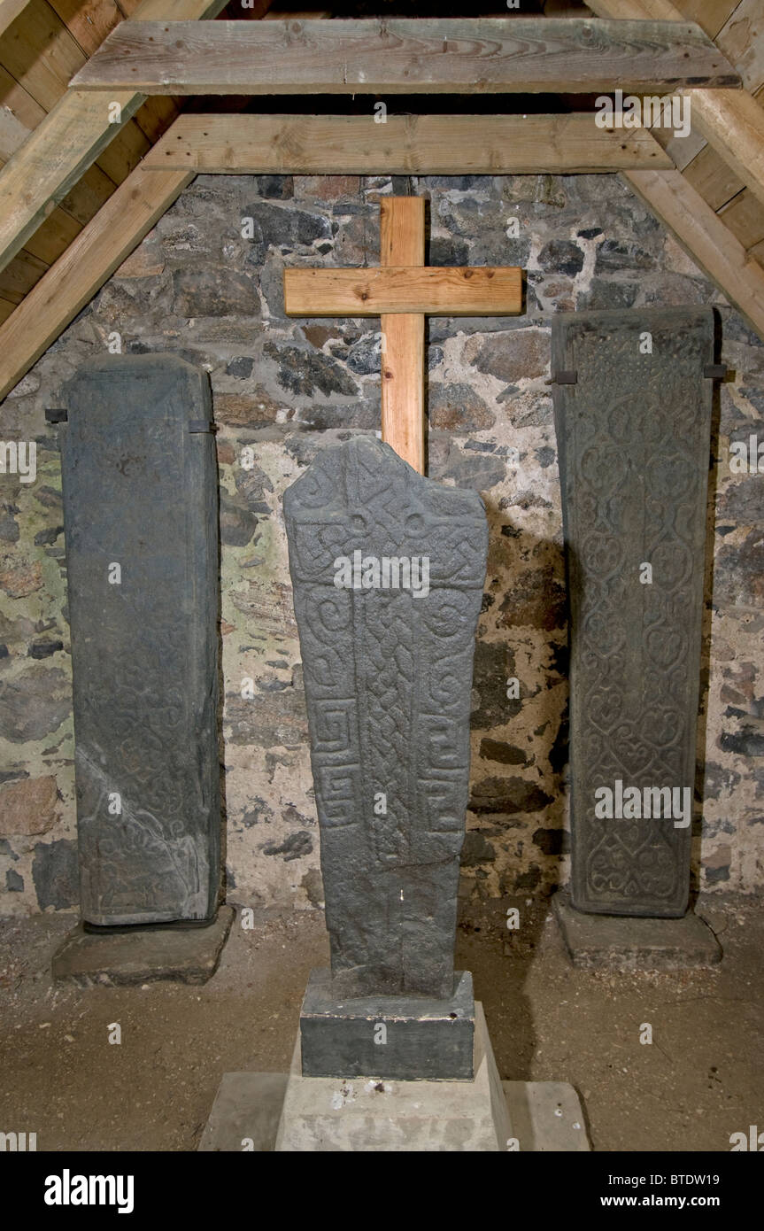 The medieval carved stones at Cille Bharra Curch, Isle of Barra, Hebrides, Scotland.  SCO 6877 Stock Photo