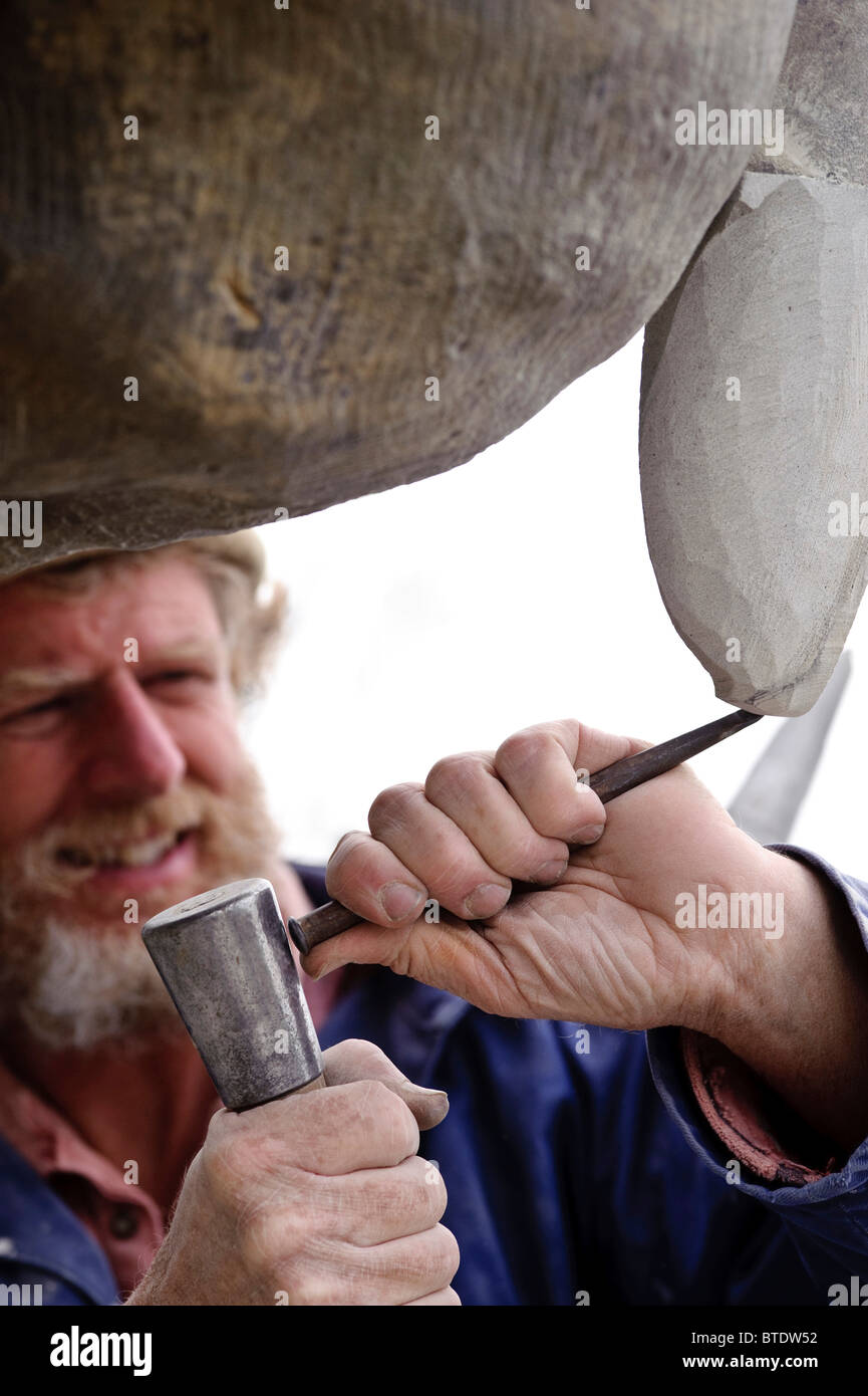 Stone Carver Tom Clarke at work on a Stone Pelican during the