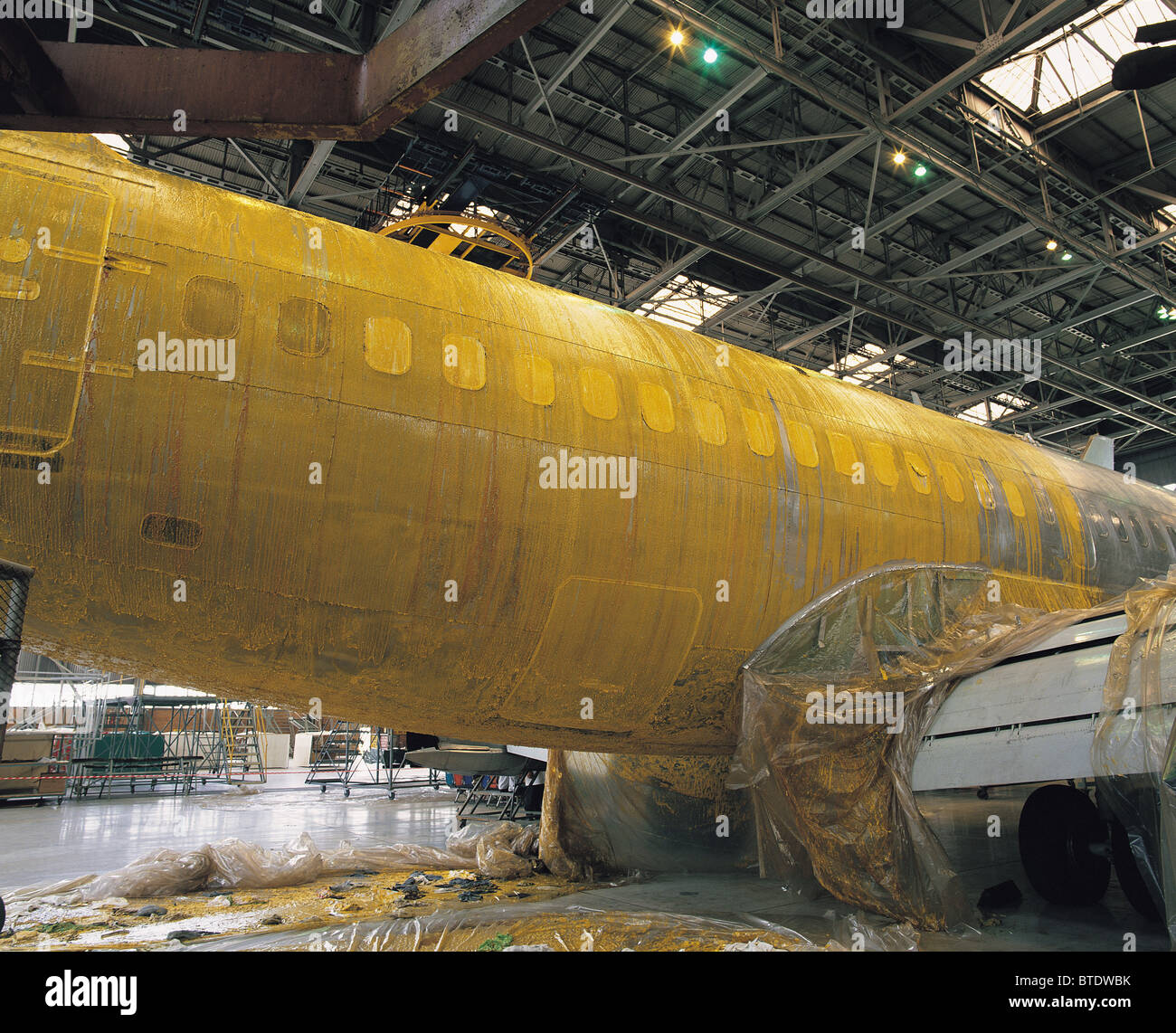 A large passenger plane is being repaired in a hanger at Johannesburg International Airport Stock Photo