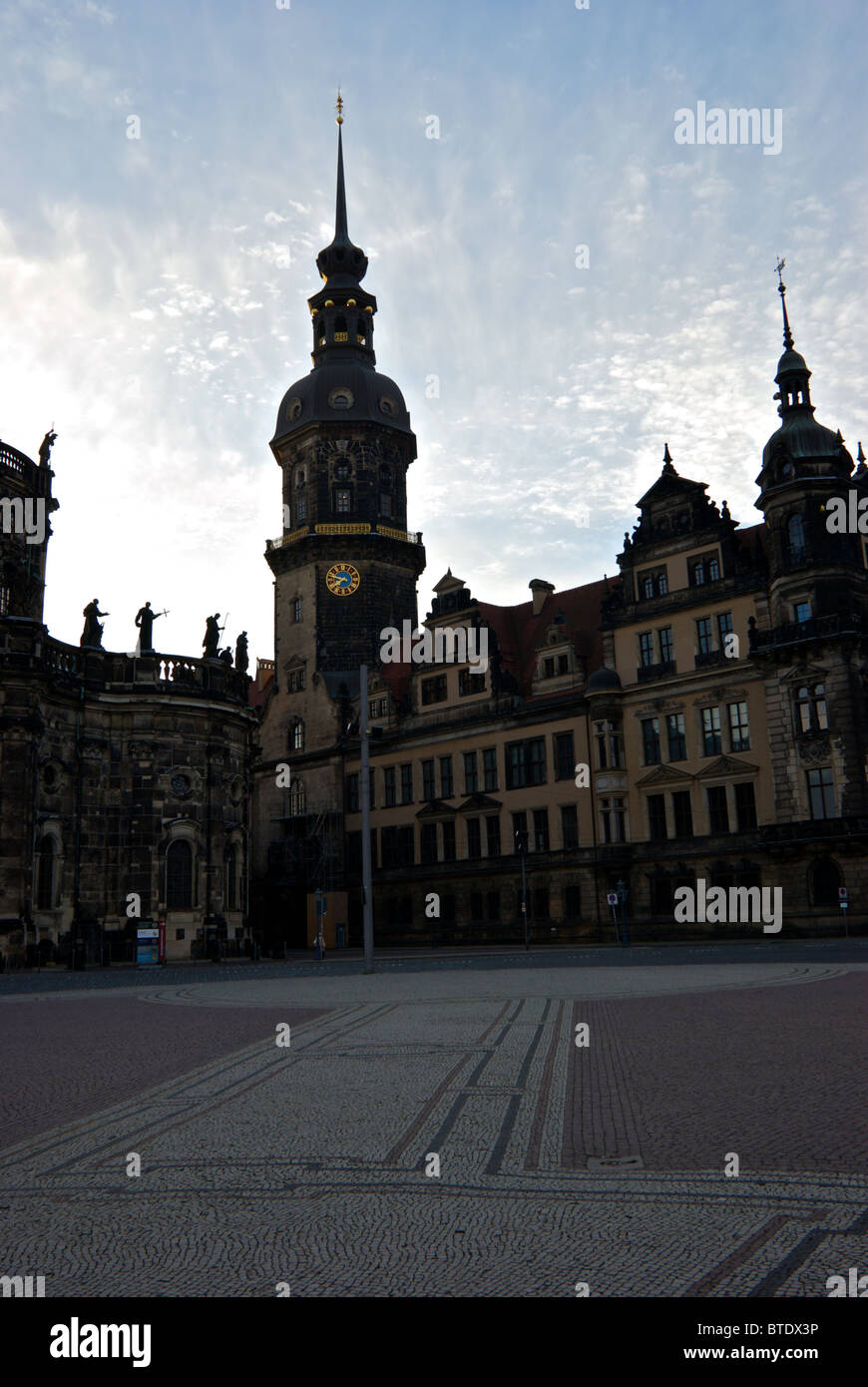Royal palace steeples and expansive stone paved mosaic Theaterplatz plaza in historic old Altstadt Dresden at sunrise Stock Photo