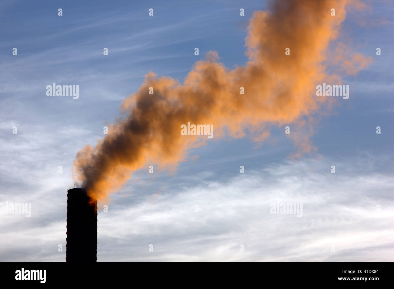 Industrial chimney, morning light, smoke coming out. Stock Photo