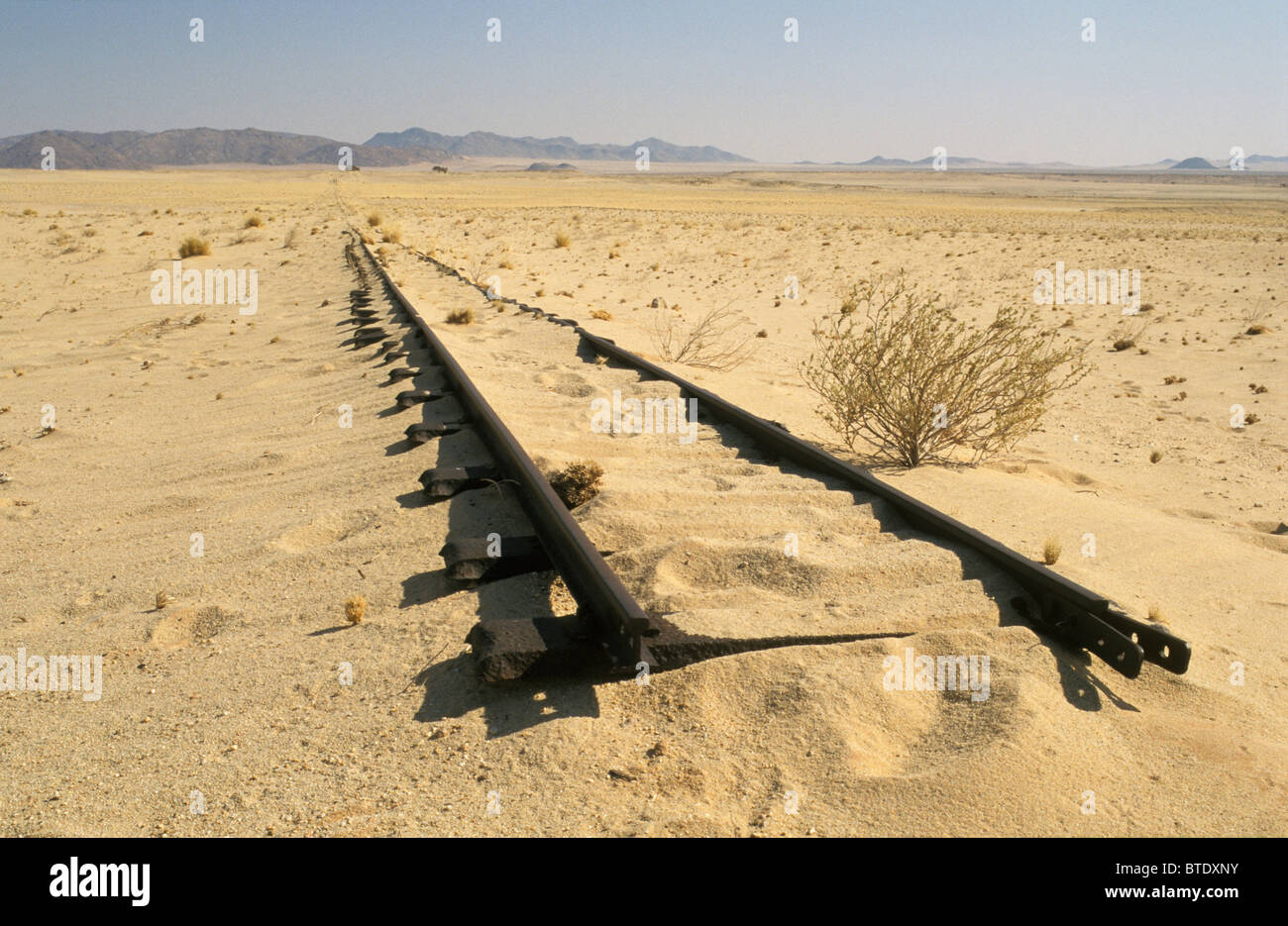 Old railway tracks ending in the middle of nowhere in the desert Stock Photo
