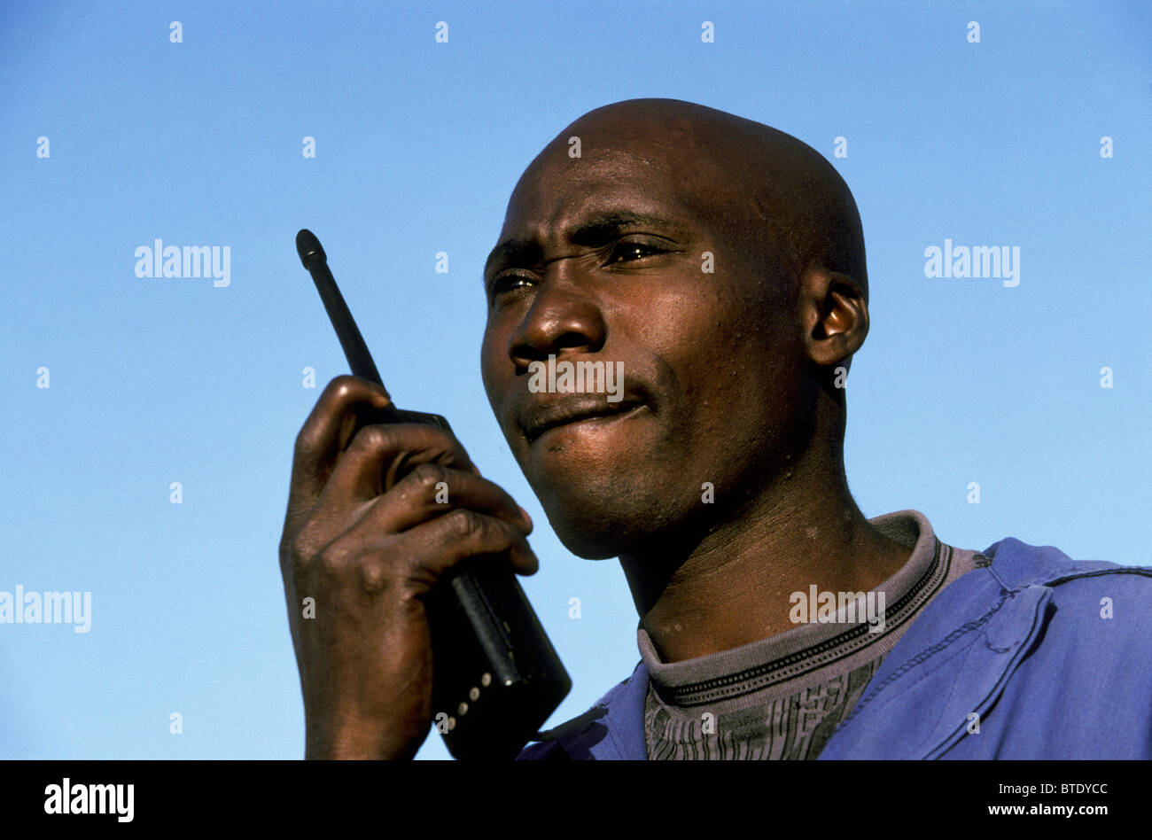 Game scout talking on a two way radio Stock Photo