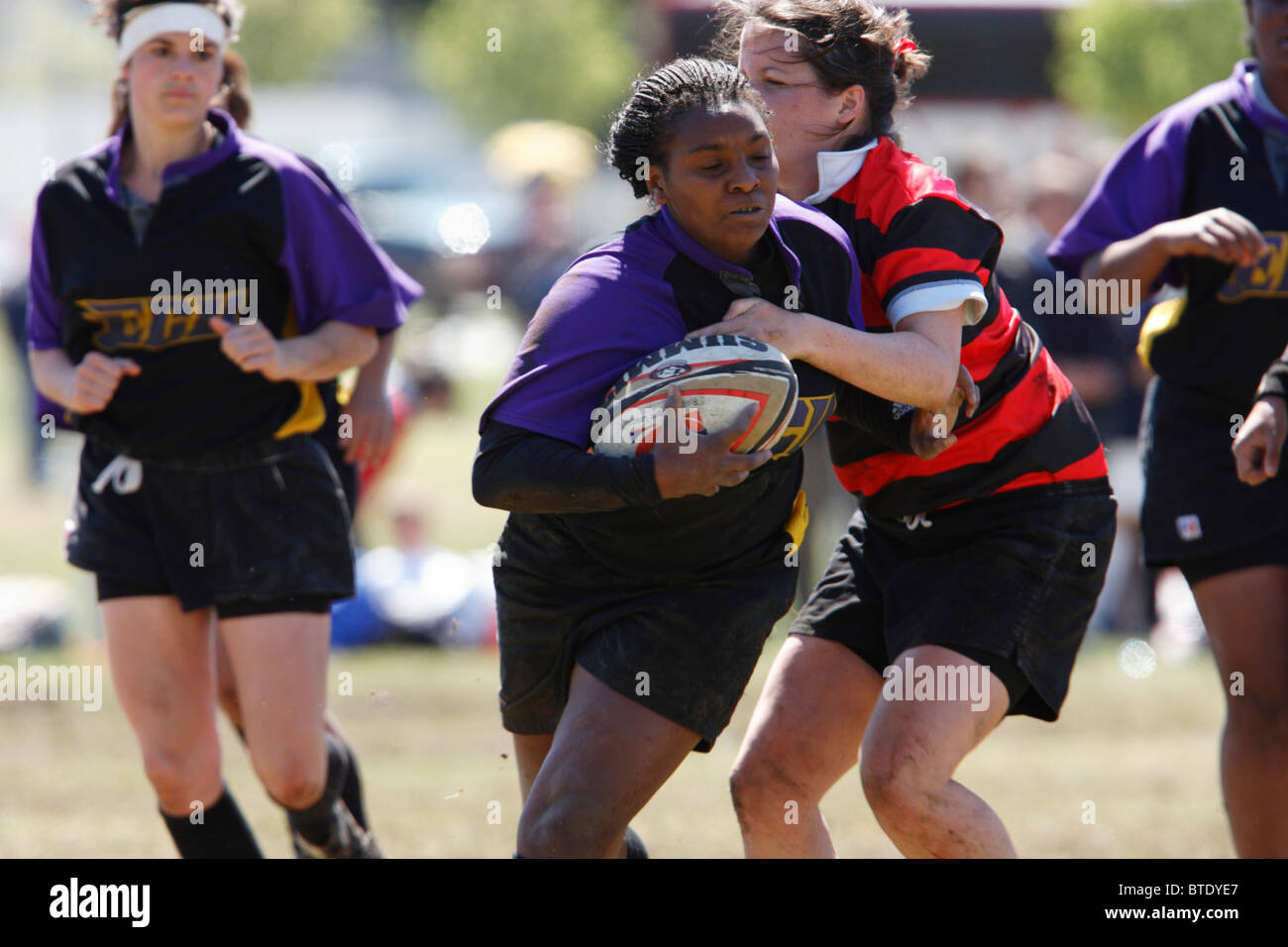 An Eastern Carolina University rugby player carries the ball during a match at the annual Cherry Blossom Rugby Tournament. Stock Photo